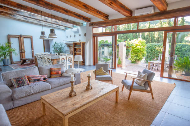Farmhouse living room with wooden beams, cozy furniture, and natural light